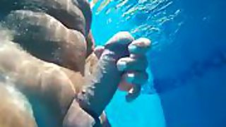 Swimming erect in a tropical pool with underwater camera