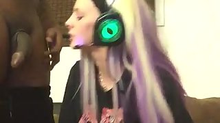 Blonde amateur girl deep throats a black cock while frolicking video games