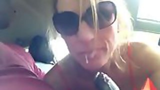 Laury sucks a black guy's cock in his car, without her husband knowing