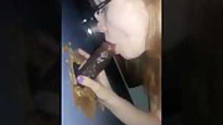 Sucking a black cock through gloryhole tasting his cum